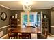 Dining room with wood floors, chandelier, and patio access with outdoor seating at 8620 Brookdale Dr, Raleigh, NC 27613
