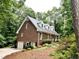 Brick home featuring a well-maintained yard with beautiful greenery and landscaping at 8620 Brookdale Dr, Raleigh, NC 27613