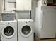 Functional laundry room with washer, dryer, and refrigerator, providing convenience for household chores at 8620 Brookdale Dr, Raleigh, NC 27613