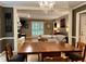 Open-concept living and dining area showcasing the fireplace, hardwood floors and a glimpse into the living room at 8620 Brookdale Dr, Raleigh, NC 27613