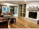 Comfortable living room with a fireplace and built-in bookcases at 8620 Brookdale Dr, Raleigh, NC 27613