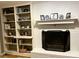 Living room with a white-painted brick fireplace, mantle, and built-in shelving to the left at 8620 Brookdale Dr, Raleigh, NC 27613