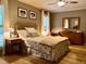 Bedroom with hardwood floors, a ceiling fan, and a comfortable bed with plush pillows at 8620 Brookdale Dr, Raleigh, NC 27613