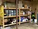 Organized storage shelves with various items, paints, and tools, maximizing space in the basement area at 8620 Brookdale Dr, Raleigh, NC 27613