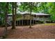 Expansive backyard showcases multi-level decking and beautiful mature trees at 8821 Oconee Ct, Chapel Hill, NC 27516