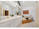 Bathroom with double vanity, soaking tub, and large mirror at 8821 Oconee Ct, Chapel Hill, NC 27516
