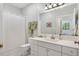 Clean bathroom featuring white cabinets, a toilet, and a shower behind a curtain at 8821 Oconee Ct, Chapel Hill, NC 27516