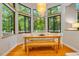 Bright dining area with large bay window overlooking lush landscaping at 8821 Oconee Ct, Chapel Hill, NC 27516