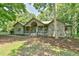 Inviting exterior showcasing the home's charming facade, complemented by mature trees and lush landscaping at 8821 Oconee Ct, Chapel Hill, NC 27516