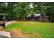 Beautifully landscaped front yard leading to a home with a welcoming porch and natural surroundings at 8821 Oconee Ct, Chapel Hill, NC 27516