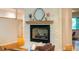 Living room fireplace with stone surround, wood mantel, and decorative mirror at 8821 Oconee Ct, Chapel Hill, NC 27516