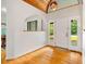 Bright foyer with hardwood floors and white walls with wood ceiling accents at 8821 Oconee Ct, Chapel Hill, NC 27516