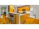 Bright kitchen with light wood cabinets, stainless appliances, and breakfast bar seating at 8821 Oconee Ct, Chapel Hill, NC 27516