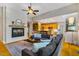 Spacious living area with brick fireplace, hardwood floors, open layout to the kitchen, and contemporary decor at 8821 Oconee Ct, Chapel Hill, NC 27516