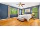 Bedroom with hardwood floors, large windows, and ensuite bath at 8821 Oconee Ct, Chapel Hill, NC 27516