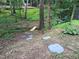 Landscaped backyard featuring rock and wood features, offering a serene escape at 905 Balmoral Dr, Cary, NC 27511