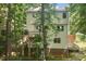 Back exterior view of the house with wooden deck and a staircase leading to the yard at 905 Balmoral Dr, Cary, NC 27511