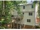 Back exterior view of house with a wooden deck surrounded by tall trees at 905 Balmoral Dr, Cary, NC 27511