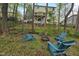 Secluded backyard area with a fire pit and Adirondack chairs among the trees at 905 Balmoral Dr, Cary, NC 27511
