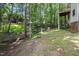 Spacious backyard with a creek, bridge, stepping stones, and Adirondack chairs, perfect for outdoor enjoyment at 905 Balmoral Dr, Cary, NC 27511