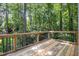 View from deck surrounded by lush green trees and a black metal railing at 905 Balmoral Dr, Cary, NC 27511
