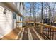 Wooden deck with metal railings featuring a view of the surrounding woods at 905 Balmoral Dr, Cary, NC 27511