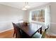 Inviting dining area with a view of the backyard and classic furnishings at 905 Balmoral Dr, Cary, NC 27511