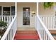 Close-up of front entrance with red stairs and white railings at 905 Balmoral Dr, Cary, NC 27511