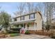 Charming two-story home with a welcoming front porch, red steps and landscaped yard at 905 Balmoral Dr, Cary, NC 27511