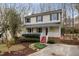 Charming two-story home with a welcoming front porch, red steps and landscaped yard at 905 Balmoral Dr, Cary, NC 27511