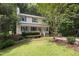 Charming two-story home nestled among mature trees with a welcoming front porch and manicured lawn at 905 Balmoral Dr, Cary, NC 27511