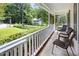 Inviting front porch featuring chairs, white railings, and a picturesque view of the neighborhood at 905 Balmoral Dr, Cary, NC 27511