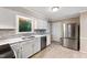 Well-appointed kitchen with tiled floors, stainless steel appliances, and stainless refrigerator at 905 Balmoral Dr, Cary, NC 27511