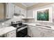 Updated kitchen boasts stainless steel appliances, a stylish backsplash, and natural light at 905 Balmoral Dr, Cary, NC 27511