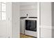 Convenient laundry room with a washer and dryer setup and storage shelves at 905 Balmoral Dr, Cary, NC 27511