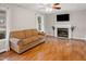 Comfortable living room featuring a fireplace and sleek, modern television and natural light at 905 Balmoral Dr, Cary, NC 27511