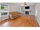 Cozy living room featuring hardwood floors, a fireplace, and ample natural light at 905 Balmoral Dr, Cary, NC 27511