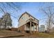 Multi-story home with a wooden deck and a brick foundation on a sunny day at 905 Balmoral Dr, Cary, NC 27511