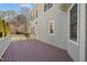 Back deck of a two story home, showing the siding, trim, and a fenced yard at 100 Maywood Way, Chapel Hill, NC 27516