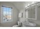Upstairs bathroom features a window and a pedestal sink at 100 Maywood Way, Chapel Hill, NC 27516