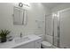 Bright bathroom featuring a white vanity, tile floors, and a glass-enclosed shower at 100 Maywood Way, Chapel Hill, NC 27516