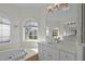 Bright bathroom with a soaking tub and double sink vanity with granite countertop at 100 Maywood Way, Chapel Hill, NC 27516