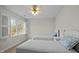 Bright bedroom with two twin beds and natural light streaming through the window at 100 Maywood Way, Chapel Hill, NC 27516