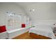 Well-lit bedroom with a daybed nook, built-in shelves, and light wood floors at 100 Maywood Way, Chapel Hill, NC 27516