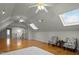 Spacious bonus room with hardwood floors, skylights, and ceiling fans at 100 Maywood Way, Chapel Hill, NC 27516
