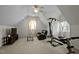 Large, carpeted bonus room with a ceiling fan, workout machine, and leather seating at 100 Maywood Way, Chapel Hill, NC 27516