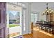 View through the front door to a formal dining room with hardwood floors and traditional chandelier at 100 Maywood Way, Chapel Hill, NC 27516