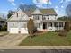 Charming two-story home with a well-manicured lawn and a two-car garage at 100 Maywood Way, Chapel Hill, NC 27516