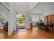 Inviting foyer with hardwood floors that leads to a dining room with modern chandelier at 100 Maywood Way, Chapel Hill, NC 27516