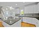 Elegant kitchen with white cabinets, granite countertops, and stainless steel appliances at 100 Maywood Way, Chapel Hill, NC 27516